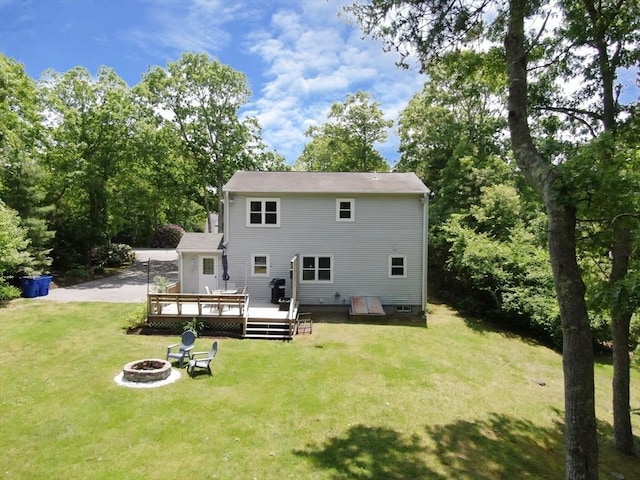 11 Winchester Ave, Bourne, MA 02532 - back of house featuring a fire pit, a deck, and a lawn
