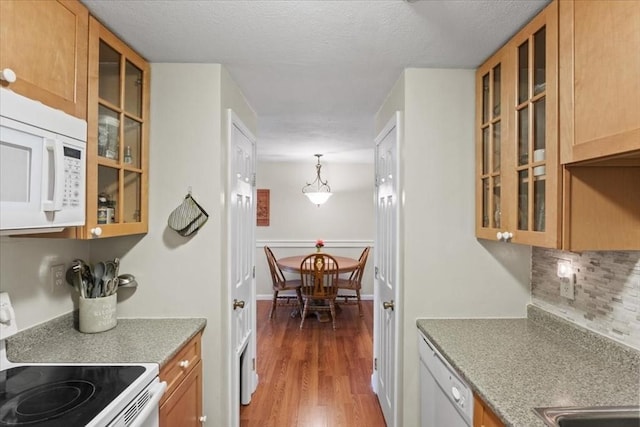 103 Grove St Unit 341, Rockland, MA 02370 - kitchen featuring white appliances, decorative backsplash, glass insert cabinets, wood finished floors, and a textured ceiling