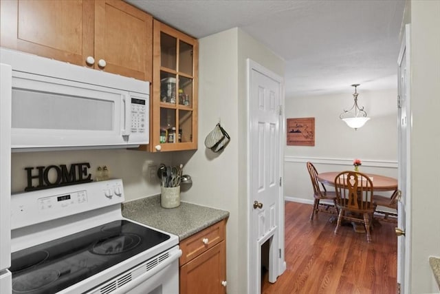103 Grove St Unit 341, Rockland, MA 02370 - kitchen with white appliances, wood finished floors, glass insert cabinets, brown cabinetry, and decorative light fixtures
