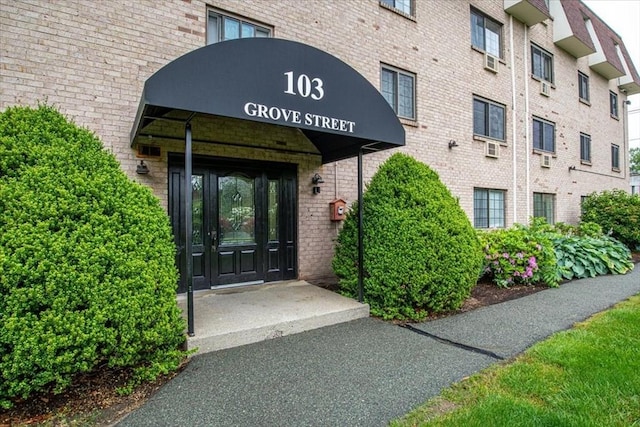 103 Grove St Unit 341, Rockland, MA 02370 - doorway to property featuring brick siding