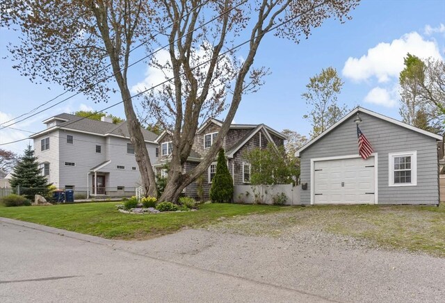 21 Grove St, Fairhaven, MA 02719 - view of front facade featuring driveway, a garage, a front lawn, and an outbuilding