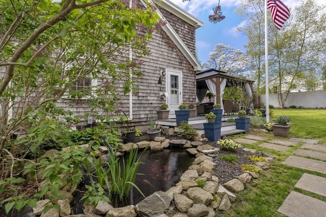 21 Grove St, Fairhaven, MA 02719 - view of property exterior featuring a gazebo, a small pond, and fence