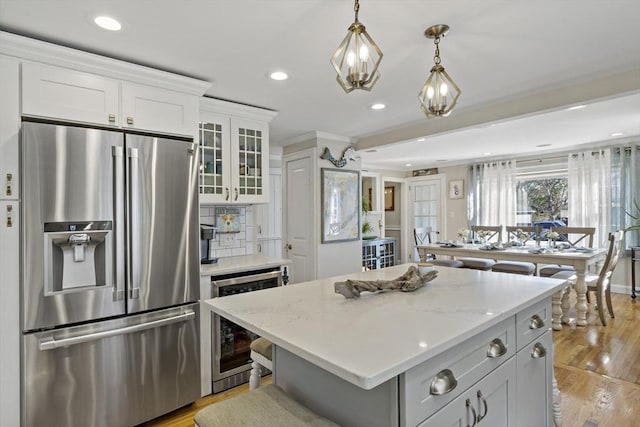 21 Grove St, Fairhaven, MA 02719 - kitchen featuring stainless steel fridge with ice dispenser, wine cooler, recessed lighting, white cabinetry, and a kitchen island