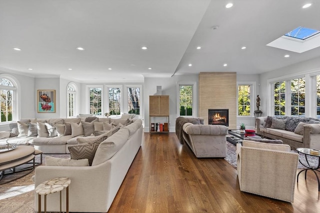 37 Radcliffe Rd, Newton, MA 02468 - living room with ornamental molding, a fireplace, dark wood-type flooring, recessed lighting, and a skylight