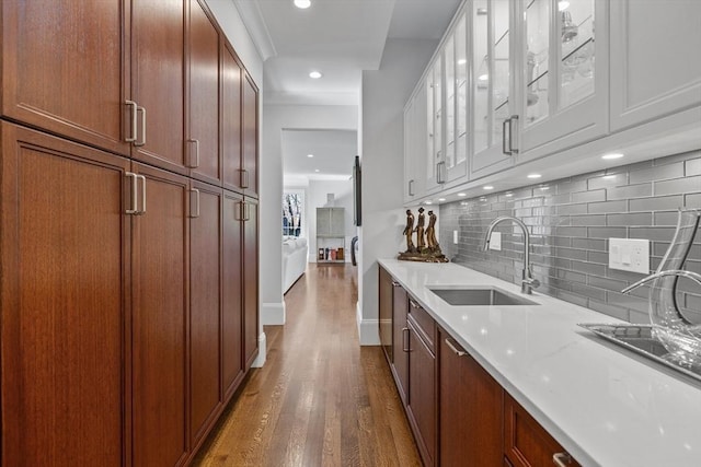 37 Radcliffe Rd, Newton, MA 02468 - bar featuring dark wood-style flooring, tasteful backsplash, a sink, baseboards, and recessed lighting