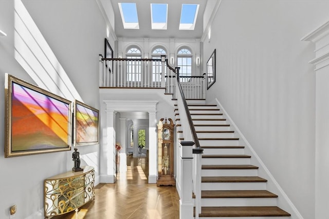 37 Radcliffe Rd, Newton, MA 02468 - entryway with crown molding, stairs, a towering ceiling, and a skylight