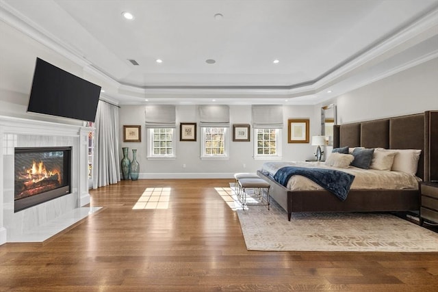 37 Radcliffe Rd, Newton, MA 02468 - bedroom featuring a tiled fireplace, wood finished floors, a raised ceiling, ornamental molding, and recessed lighting