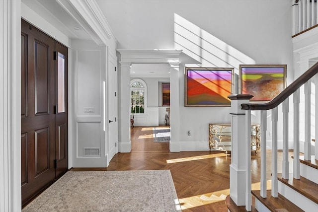 37 Radcliffe Rd, Newton, MA 02468 - entrance foyer with visible vents, ornamental molding, decorative columns, a decorative wall, and stairway