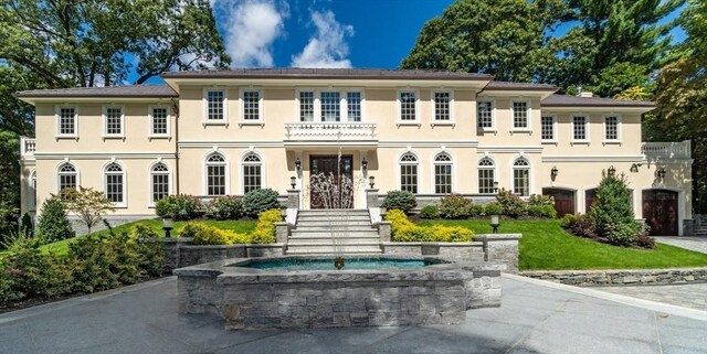 37 Radcliffe Rd, Newton, MA 02468 - view of front of house with stucco siding and a balcony