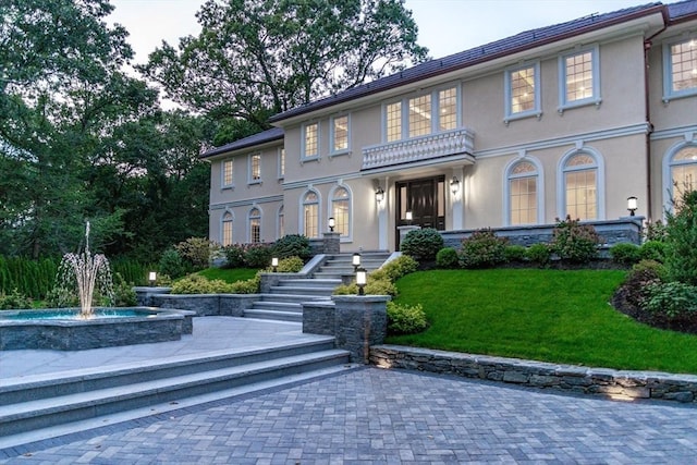 37 Radcliffe Rd, Newton, MA 02468 - view of front facade with stucco siding and a front yard