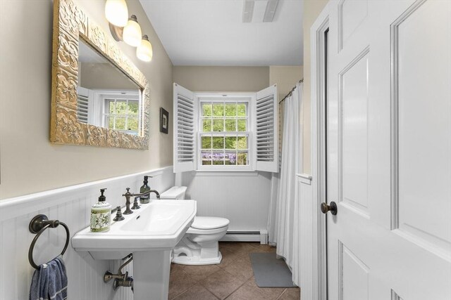 126 Arrow Head Rd, Marshfield, MA 02050 - full bathroom featuring baseboard heating, a wainscoted wall, tile patterned flooring, toilet, and curtained shower