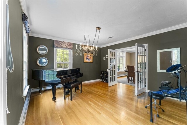 126 Arrow Head Rd, Marshfield, MA 02050 - living area featuring french doors, light wood-style floors, crown molding, a chandelier, and baseboards
