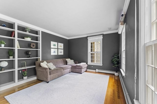 126 Arrow Head Rd, Marshfield, MA 02050 - living area with baseboard heating, wood finished floors, ornamental molding, and baseboards