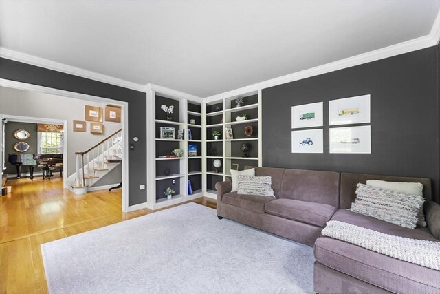 126 Arrow Head Rd, Marshfield, MA 02050 - living area with wood finished floors, ornamental molding, built in features, baseboards, and stairway