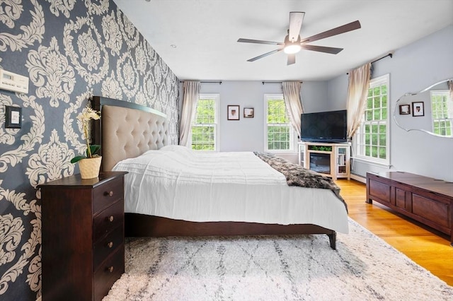 126 Arrow Head Rd, Marshfield, MA 02050 - bedroom featuring wood finished floors, multiple windows, wallpapered walls, and a ceiling fan
