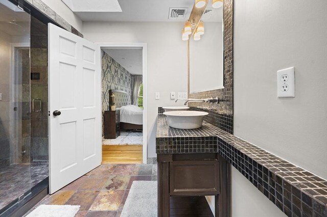 126 Arrow Head Rd, Marshfield, MA 02050 - ensuite bathroom with a shower stall, stone finish floors, backsplash, and vanity