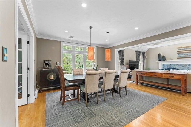 126 Arrow Head Rd, Marshfield, MA 02050 - dining space featuring a fireplace, light wood finished floors, crown molding, and recessed lighting