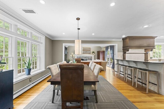 126 Arrow Head Rd, Marshfield, MA 02050 - dining room with a baseboard radiator, recessed lighting, a fireplace, ornamental molding, and light wood-style floors