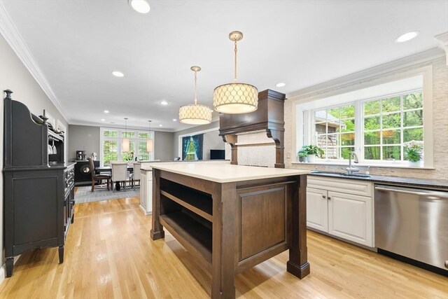 126 Arrow Head Rd, Marshfield, MA 02050 - kitchen with stainless steel dishwasher, a sink, ornamental molding, a center island, and white cabinets