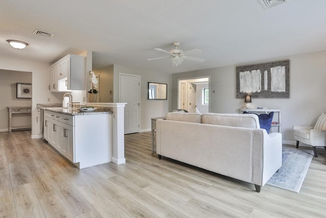 181 Littleton Rd Unit 213, Chelmsford, MA 01824 - living area featuring baseboards, light wood-style flooring, and a ceiling fan