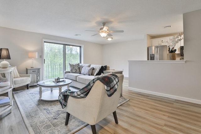 181 Littleton Rd Unit 213, Chelmsford, MA 01824 - living area with ceiling fan, light wood-style flooring, and baseboards