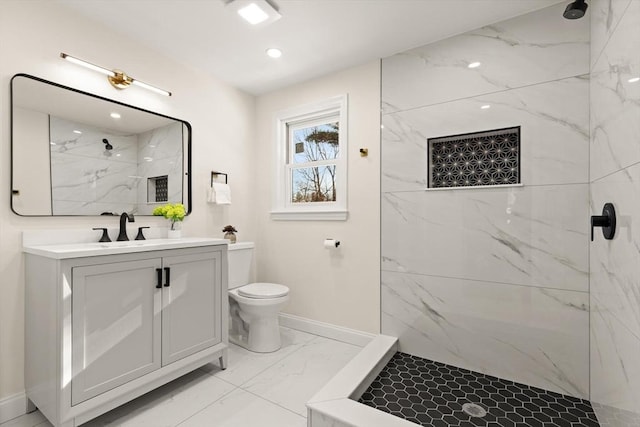 bathroom featuring a marble finish shower, baseboards, toilet, marble finish floor, and vanity