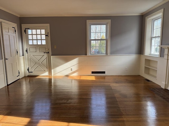 interior space with hardwood / wood-style flooring, plenty of natural light, and ornamental molding