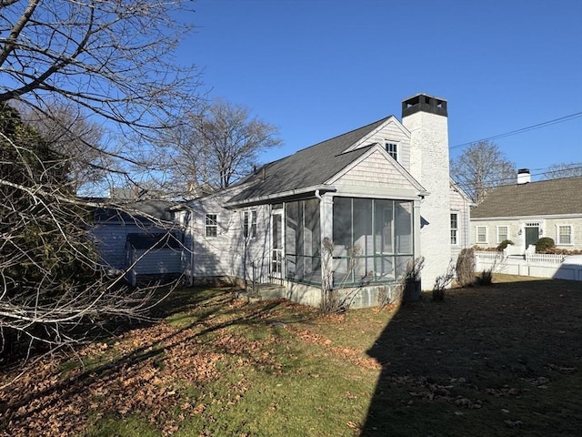 rear view of property with a sunroom