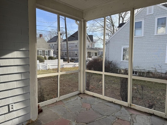 unfurnished sunroom with plenty of natural light