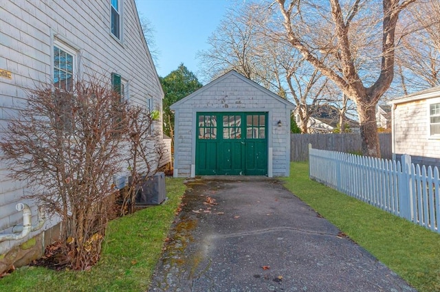 view of outbuilding featuring cooling unit and a garage