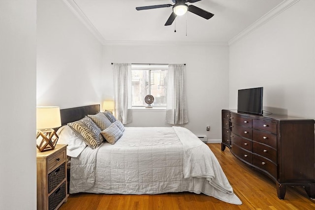 bedroom featuring hardwood / wood-style floors, ceiling fan, and ornamental molding