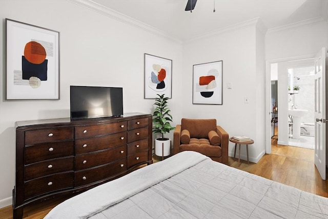 bedroom with light wood-type flooring, connected bathroom, ceiling fan, and crown molding