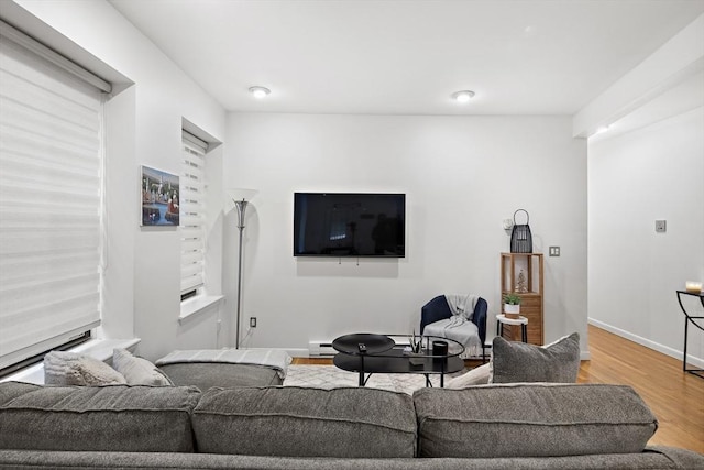 living room featuring hardwood / wood-style flooring and a baseboard heating unit