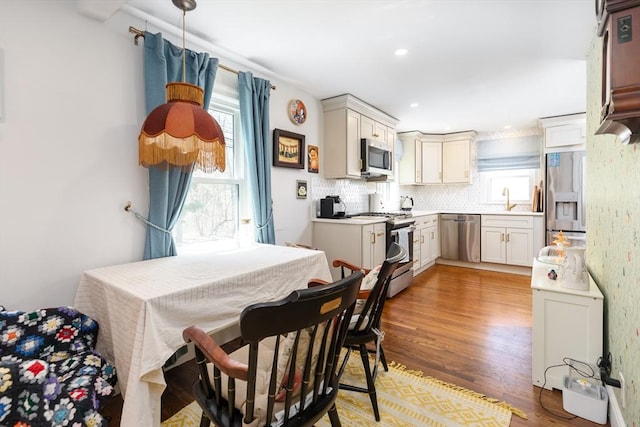 dining area featuring light wood-style floors and recessed lighting