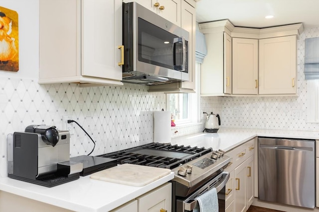 kitchen with light countertops, backsplash, and appliances with stainless steel finishes
