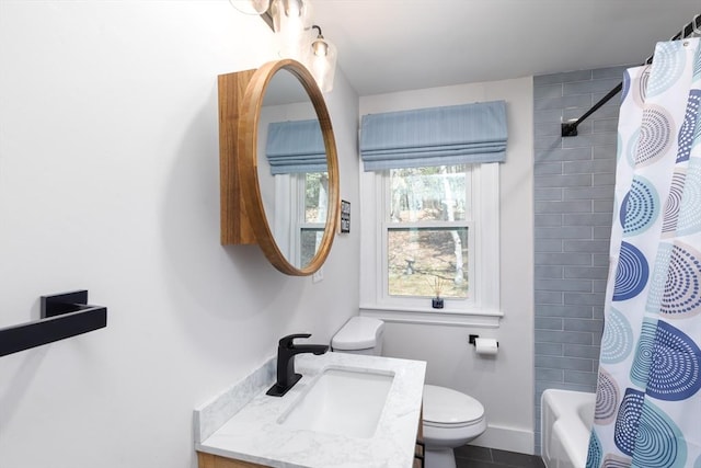 bathroom featuring vanity, shower / bath combo, and toilet