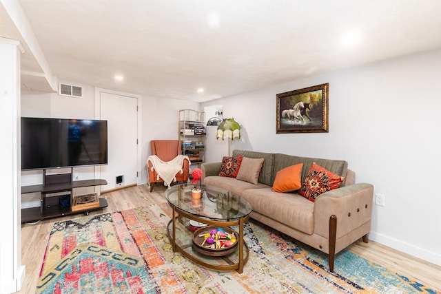 living area with recessed lighting, visible vents, and wood finished floors