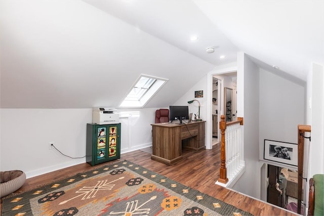 home office featuring baseboards, wood finished floors, and lofted ceiling with skylight