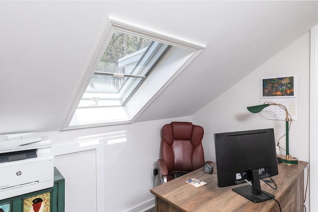 home office with vaulted ceiling with skylight