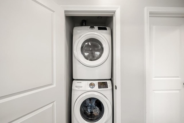 washroom featuring stacked washing maching and dryer and laundry area