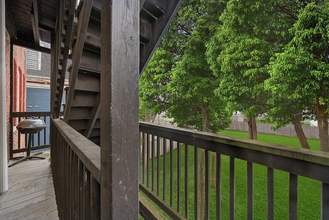 wooden terrace featuring a yard