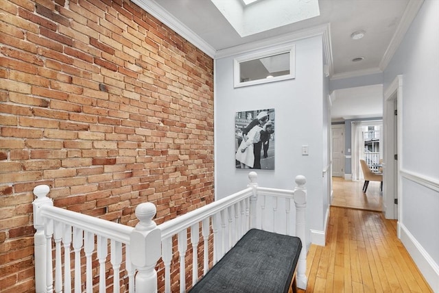 9-11 Linley Ter Unit 2, Boston, MA 02127 - hallway with an upstairs landing, light wood-type flooring, crown molding, a skylight, and brick wall