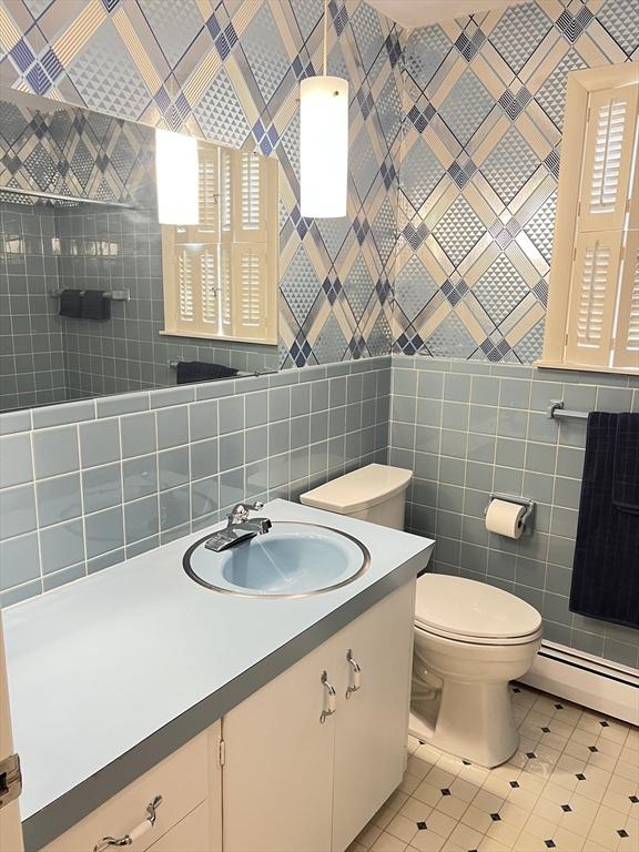216 Bel Air Dr, Longmeadow, MA 01106 - bathroom with a baseboard heating unit, tile patterned floors, tile walls, and vanity