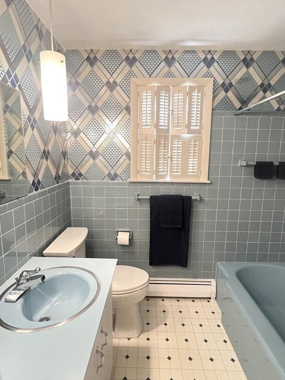 216 Bel Air Dr, Longmeadow, MA 01106 - bathroom featuring tile walls, a tub, baseboard heating, and vanity