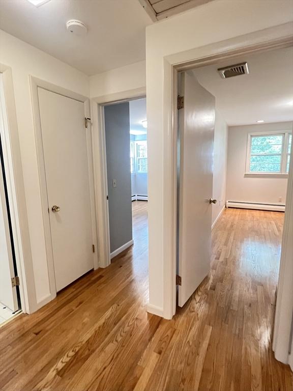 216 Bel Air Dr, Longmeadow, MA 01106 - hall with baseboard heating and light wood finished floors