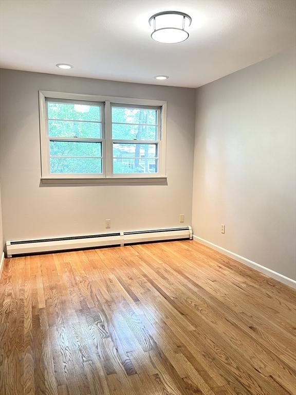 216 Bel Air Dr, Longmeadow, MA 01106 - unfurnished room with baseboard heating and wood finished floors
