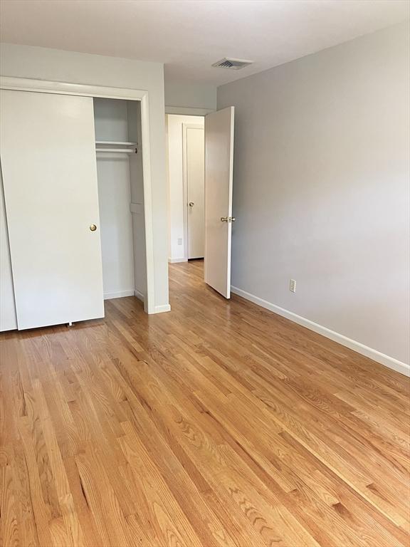 216 Bel Air Dr, Longmeadow, MA 01106 - unfurnished bedroom featuring light wood finished floors and a closet