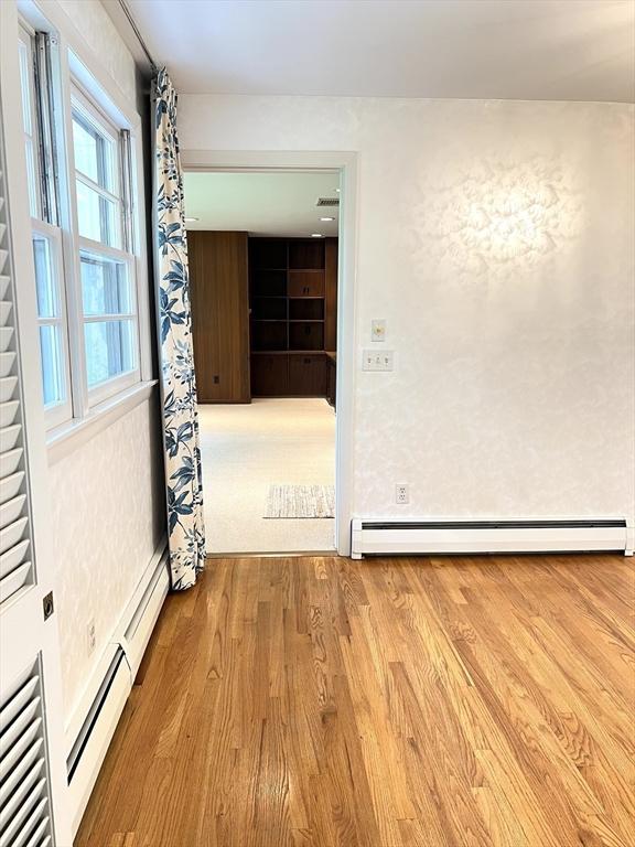 216 Bel Air Dr, Longmeadow, MA 01106 - spare room featuring baseboard heating and wood finished floors