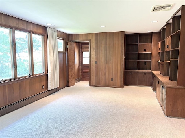216 Bel Air Dr, Longmeadow, MA 01106 - unfurnished living room with light carpet, wood walls, recessed lighting, and a baseboard heating unit