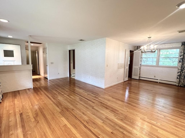 216 Bel Air Dr, Longmeadow, MA 01106 - unfurnished living room with baseboard heating, a chandelier, light wood-style flooring, and recessed lighting
